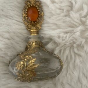 Vintage Glass Perfume Bottle with Gold Accents
IT DOES NOT HAVE THE STICK